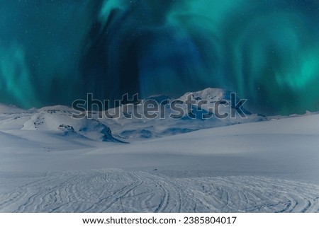 Scenic close up photo on night sky with northern green lights over mountains. Scandinavian night winter landscape, Norway, Sweden winter travel destinations