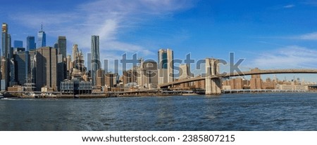 Panorama view of New York City featuring Manhattan midtown business district office buildings near Brooklyn Bridge USA