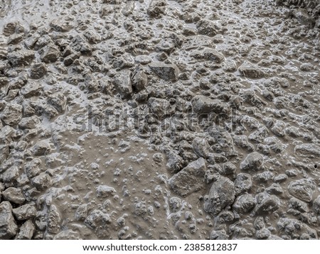 Texture of ready mixed concrete cement mortar. close up fresh concrete.wet mixed concrete with gravel texture Royalty-Free Stock Photo #2385812837
