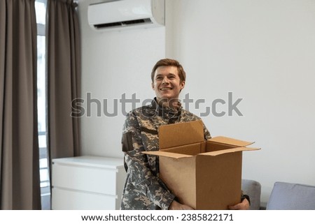 military man holding a box
