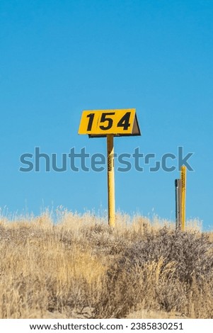 Aerial Natural Gas Marker with Dry Wyoming Plateau in the background and Dry Shubland