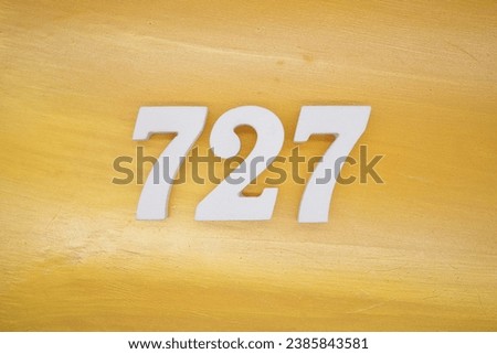 The golden yellow painted wood panel for the background, number 727, is made from white painted wood.