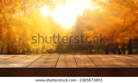The empty rustic wooden table for product display with blur background of autumn forest. Exuberant image. 
 background of autumn landscape. Concept Autumn nature and product advertising. copy space.

