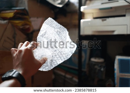 Selective focus photo of hand holding used trash package