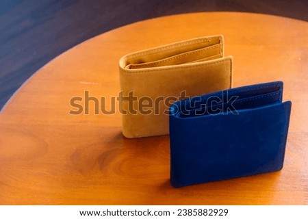 leather money bag Place the picture on a wooden table. Arrange props and elements for taking photos. Promotional items, natural light, product photography props