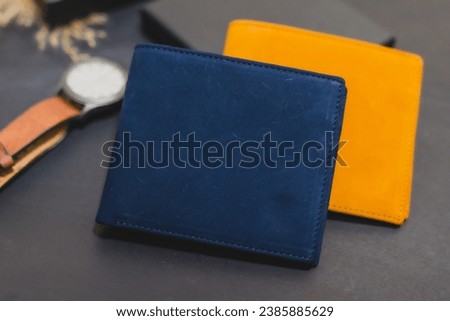 leather wallet Place the picture on a black background. There are dried grass flowers as a scene element. Arrange props and elements for the photoshoot. Promotional items Studio lighting Product photo