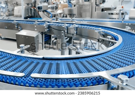 Empty modern conveyor belt of production line, part of industrial equipment in factory plant. Automatic system line