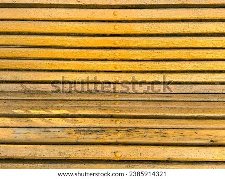 Yellow wooden boards on a bench as an abstract background. Texture.