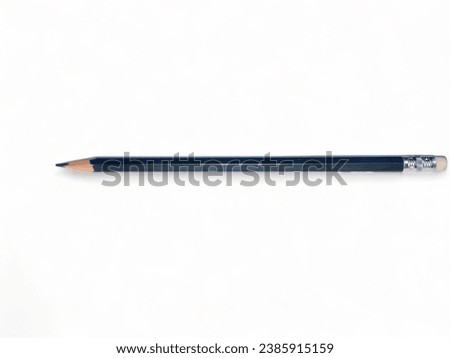 The image shows a black pencil resting on a white surface. The pencil is simple in design, with a cylindrical barrel and a pointed tip. The surface is also simple, with a smooth, matte finish.