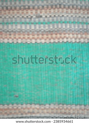 Unfocused on Old green rugs with colorful line