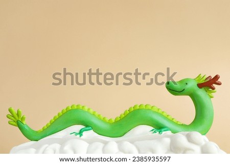 The green dragon statue on light brown background. 2024 New Year. Chinese horoscope, Symbol of the new year 2024.