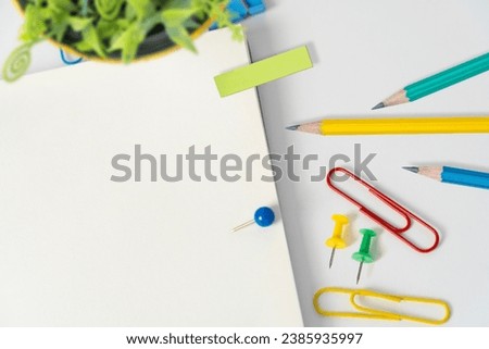 Important information presented on a table with pens, notebooks, paper clips and notes around Important information displayed on a table with clips, pencils and notes around