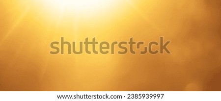 Beautiful blurry soft yellow sparkling sunlight bursting through orange spring defocused branches of old red, brown trees growing outside. sunrays beams                           Royalty-Free Stock Photo #2385939997