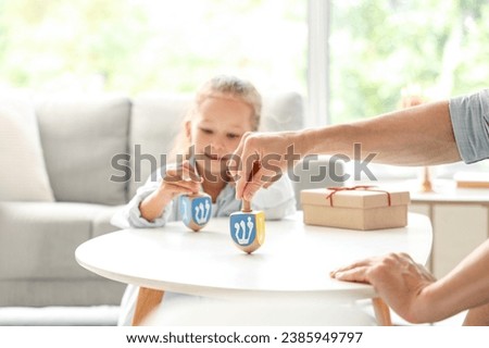 Little girl with her father celebrating Hanukkah at home