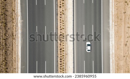 Aerial top down view of a three lane major highway. transportation concept Royalty-Free Stock Photo #2385960955