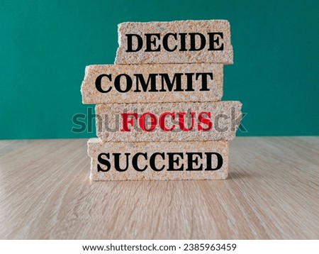 Concept word Decide Commit Focus Succeed on beautiful brick blocs. Beautiful green background, wooden table. Business decide commit focus succeed concept. Copy space.