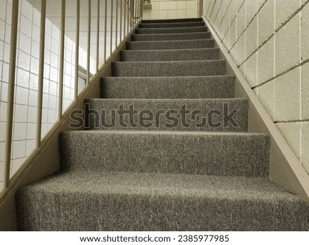 Gray Staircase looking up in apartment hallway