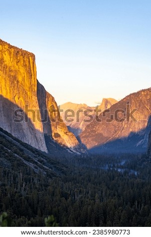 Sunset in Yosemite National Park, CA with view of the Half-Dome and El Capitan cliffs. Royalty-Free Stock Photo #2385980773