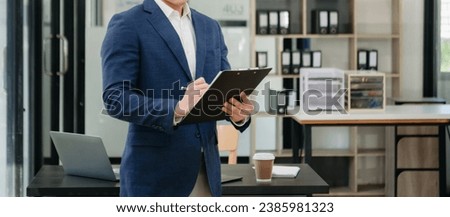 Businessman using on smartphone and tablet and laptop at moderm office as concept