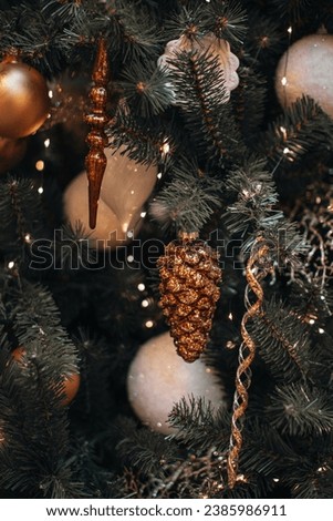 Festive mood. Winter holiday concept. Forest golden glittering cone and festive ornaments hanging on the Christmas tree. New Year's composition.