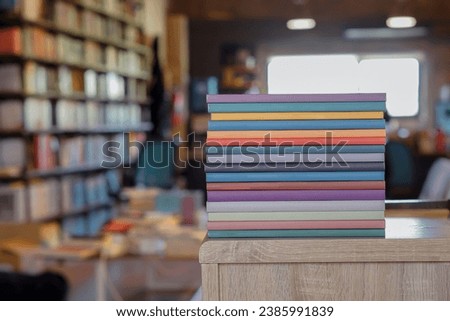 Stack of colorful books on wooden desk in the library room background. Education and knowledge concept. Pile of books to read. Royalty-Free Stock Photo #2385991839