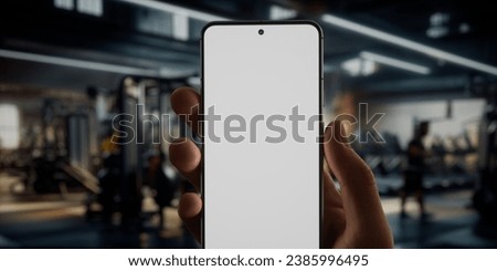 CU Caucasian man using phone in a gym, coaching training sports blank smartphone screen application app mockup