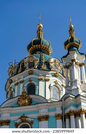 St. Andrew's church domes with golden cross on blue sky background. Kyiv city, Ukraine. Architecture and religion concept