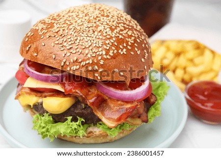 Delicious burger with bacon, patty and vegetables on table, closeup