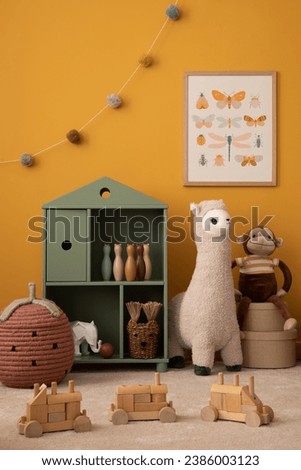Interior design of warm kids room with mock up poster frame, green shelf, plush lama, yellow wall, monkey, brown bedding, wooden block, garland on wall and personal accessories. Home decor. Template.