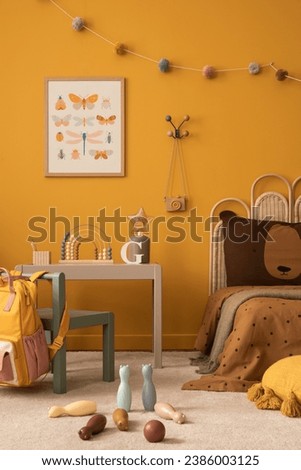 Sunny composition of kids room interior with mock up poster frame, gray desk, green chair, plush toys, guitar, garland on wall, rug, wooden block and personal accessories. Home decor. Template.