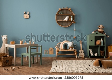 Cozy composition of kid room interior with round shelf, gray desk, green armchair, blue wall, braided rug, plush toys, braided basket, block toys and personal accessories. Home decor. Template. 