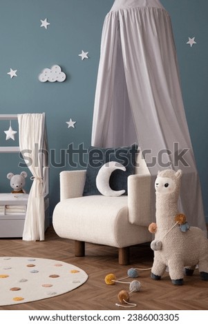 Interior design of cozy child room interior with bed, stylish rack, armchair, blue wall, round rug, colorful toys, guitar, books, ornament on wall and personal accessories. Home decor. Template.