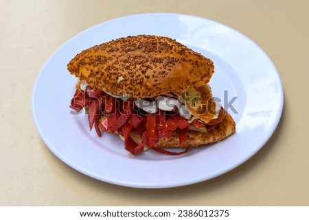 Close-up shot of Izmir's famous Turkish Traditional Kumru Sandwich, Ceşme Kumru, patso ingredients ready to eat salami, soudjouk, tomato, cheddar cheese and fried cheese. Yengen sandvic.