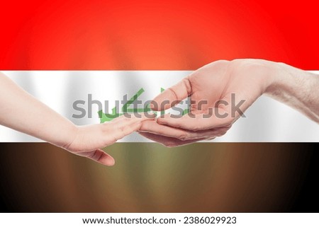 Iraqi baby and parent hands on the background of flag of Iraq Help, aid, support, charity concept
