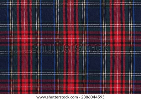 texture traditional Scottish tartan fabric in red, green and blue check. background for your design close up Royalty-Free Stock Photo #2386044595