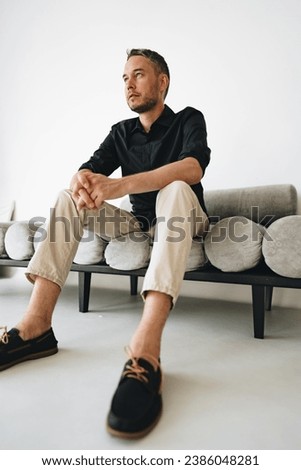 Portrait of a man in black shirt posing in photostudio