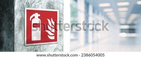 Fire estinguisher sign on an industrial style wall. Close up of a sign in the building corridor. Selective focus image. Emergency sign.
