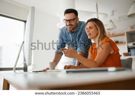 Programmers cooperating at IT company developing apps Royalty-Free Stock Photo #2386055465