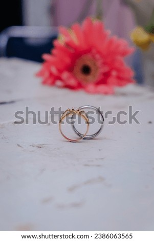 a pair of rings on a wooden table