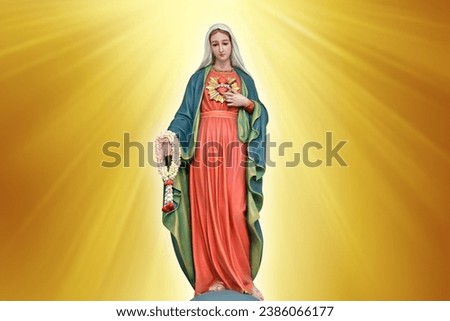 Statue of Our lady of grace virgin Mary with beautiful abstract golden colored background and wallpaper in sweet color. at Thailand. Royalty-Free Stock Photo #2386066177