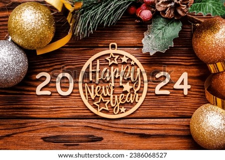 Happy new year 2024 on wooden brown background Royalty-Free Stock Photo #2386068527