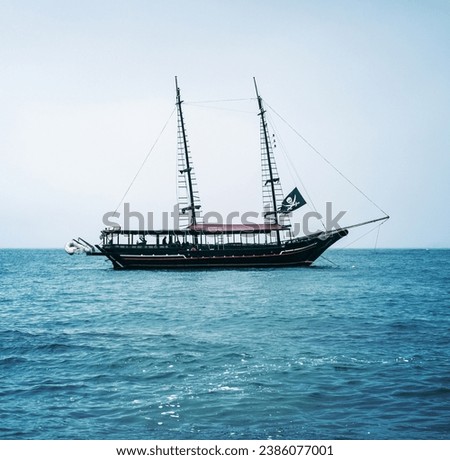 Pirate ship on the high seas, horizontal landscape photo, Tour boat, Piracy on the beach. Brazilian Sea, Ilha Bela. Calm sea.