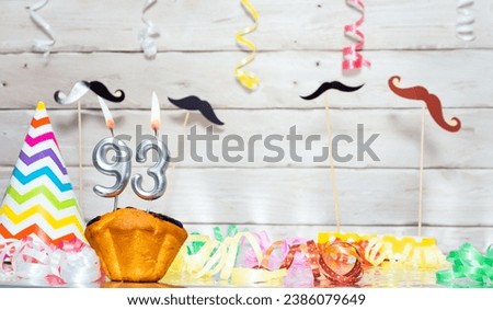 Birthday with number  93. Date of birth with number and candles, copy space. Anniversary background with cake or muffin with burning candles. Keative postcard congratulations. Royalty-Free Stock Photo #2386079649