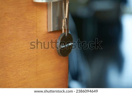 sign of make up room sign hanged on hotel doorknob