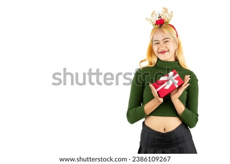 Woman in green long sleeve crop sweatshirt holding red box with white ribbon bow isolated on white background. 