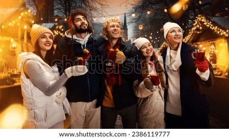 Group portrait of happy cheerful people, friends with cup of hot warming mulled-wine and enjoying moment before New Year Day. Concept of national traditions, winter holidays, fashion, festivities