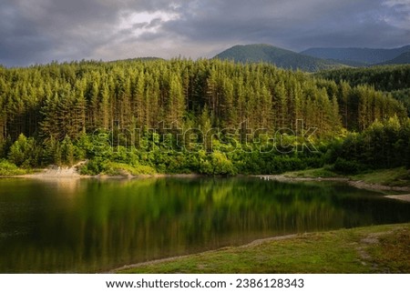 Beautiful artificial lake Krinec at summer in Bansko, Pirin Mountain, Bulgaria Royalty-Free Stock Photo #2386128343