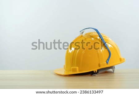 Yellow safety helmet,glasses  for construction workers. Protective clothing and accessories for employees.
