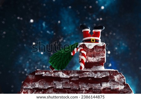 Santa's legs stick out of the chimney. Night, starry sky, Christmas background.