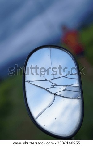 Broken motorcycle side mirror Beautiful rice field background on the mountain On the background of green mountains beautiful blue sky